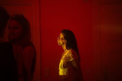 Visitors viewing a video installation at the exhibition