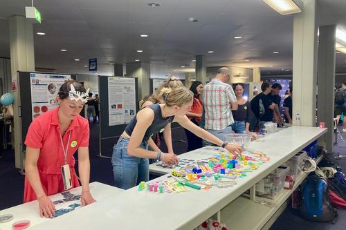 X-Student Research Group students engaging visitors at their booth during LNDW 2025