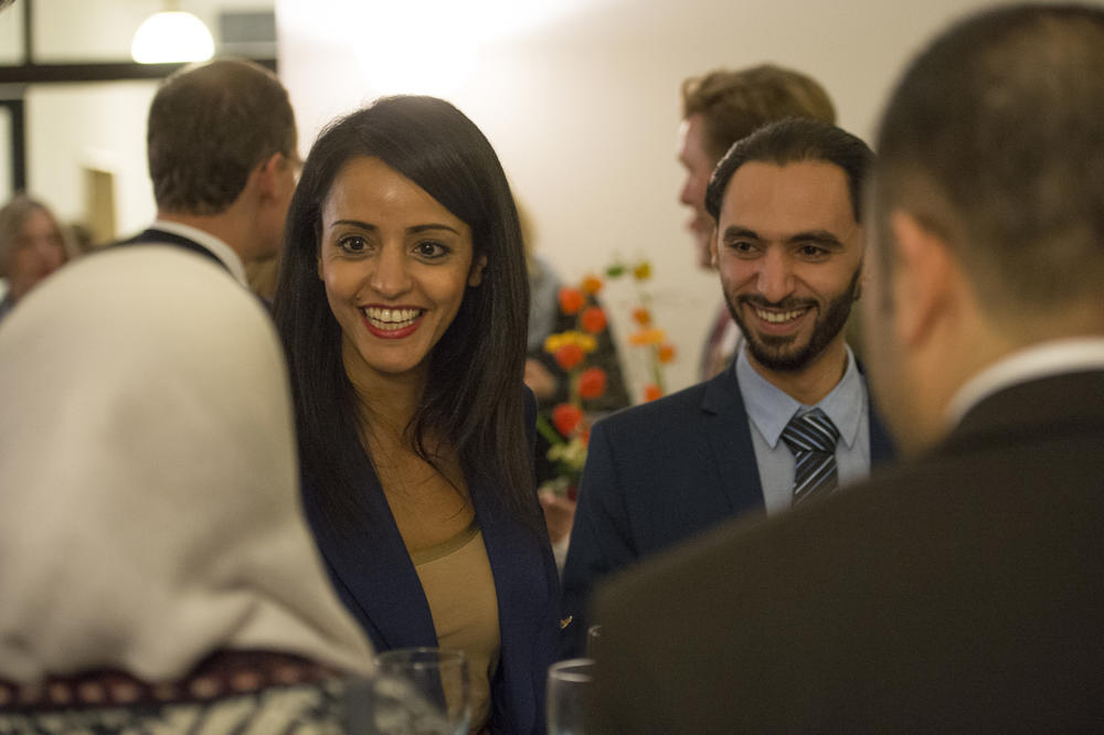 Sawsan Chebli, who represents the state of Berlin in the German federal government and is State Secretary for Civic Engagement and Intercultural Affairs, and Muhammed Al Zeen talking with Raghad Koko (at left, from back) and Mohamed Ali Mohamed.