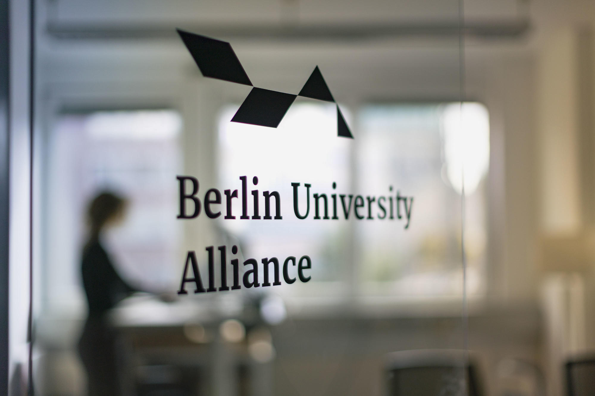 Berlin University Alliance logo on glass wall