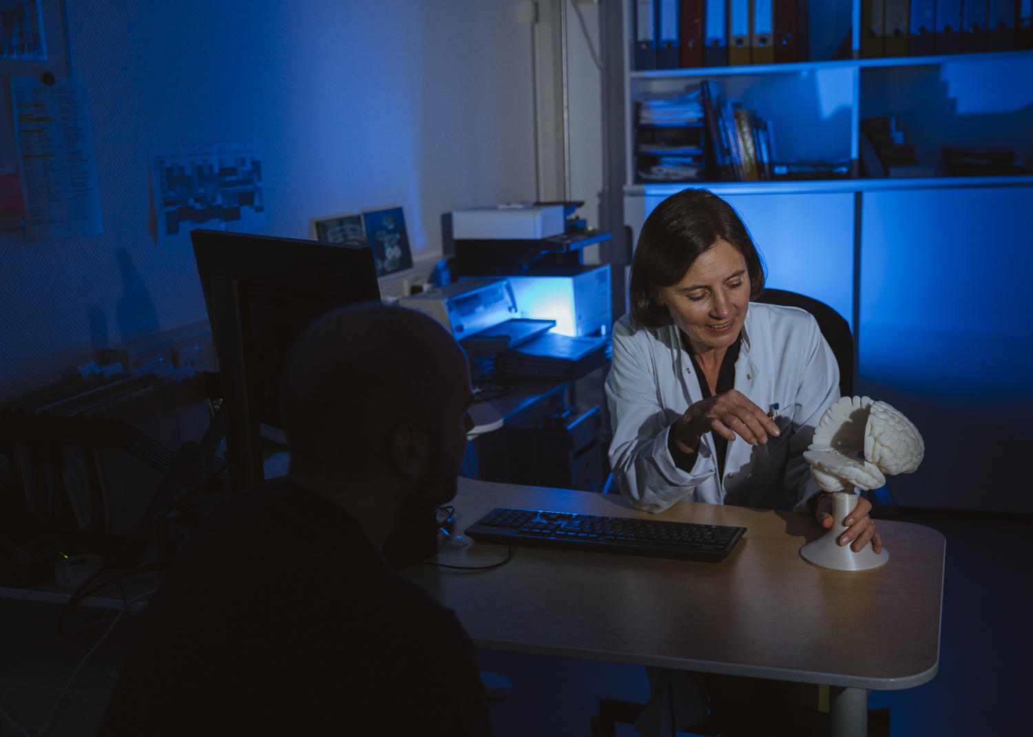 NeuroCure scientist talking to a patient