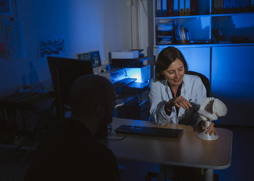 NeuroCure scientist talking to a patient